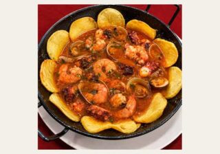 Octopus with clams, prawns and potatoes at Sidrería Cabruñana in Avilés